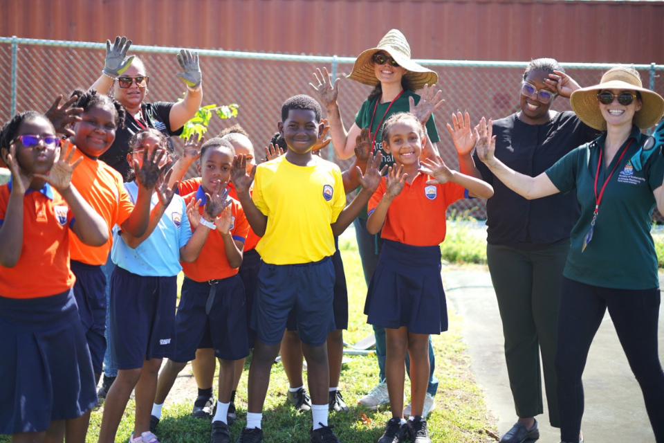 Group of students from Theoline L McCoy previously called Bodden Town Primary School  celebrate and pose for a picture after participating in the national tree planting programme led by the cayman islands government.